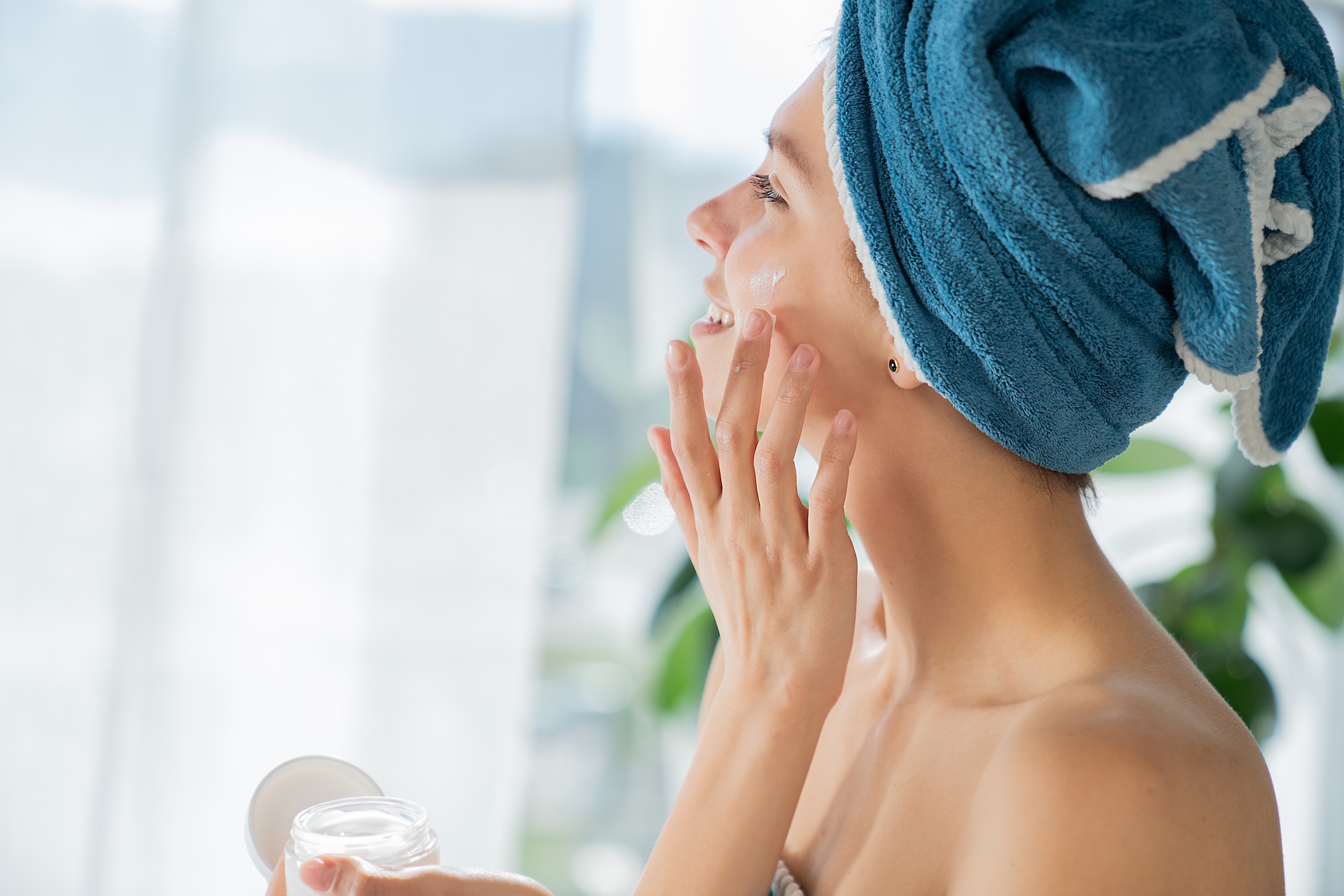 A young woman applying gentle skincare products before visit the team at Vitality Medical Wellness Center for RF Microneedling near Brentwood, TN.